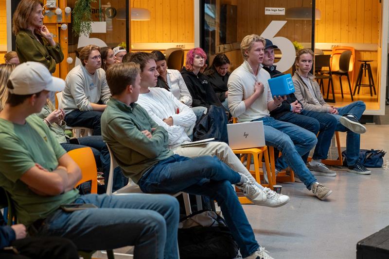 15 ungdommer sitter i et rom, og en gutt snakker. Foto: Martin Hansen, NTNU Energy Transition Initiative.